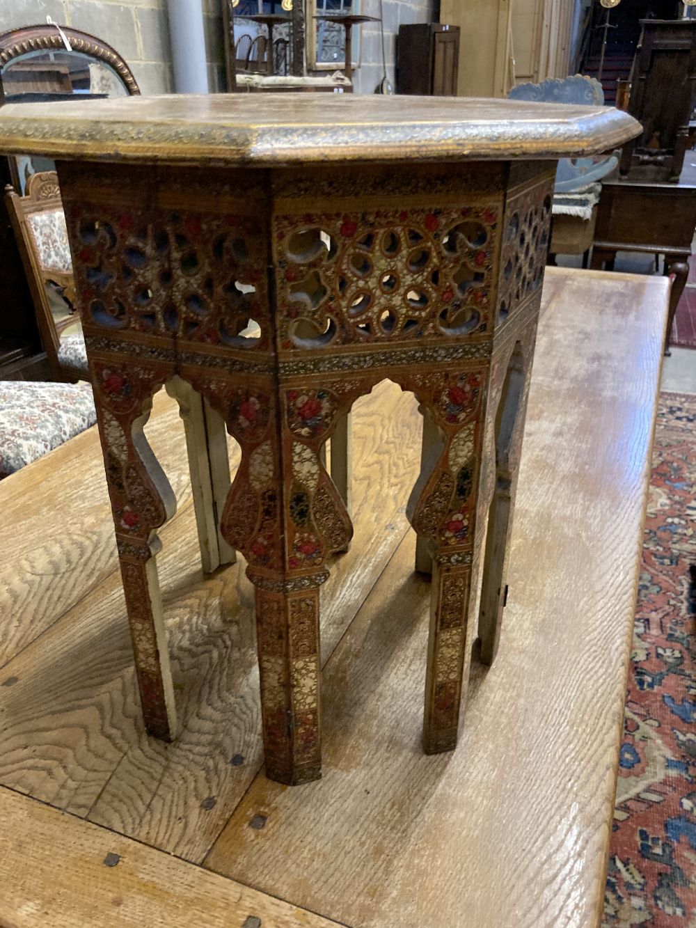 An Indian octagonal painted occasional table, width 50cm height 54cm